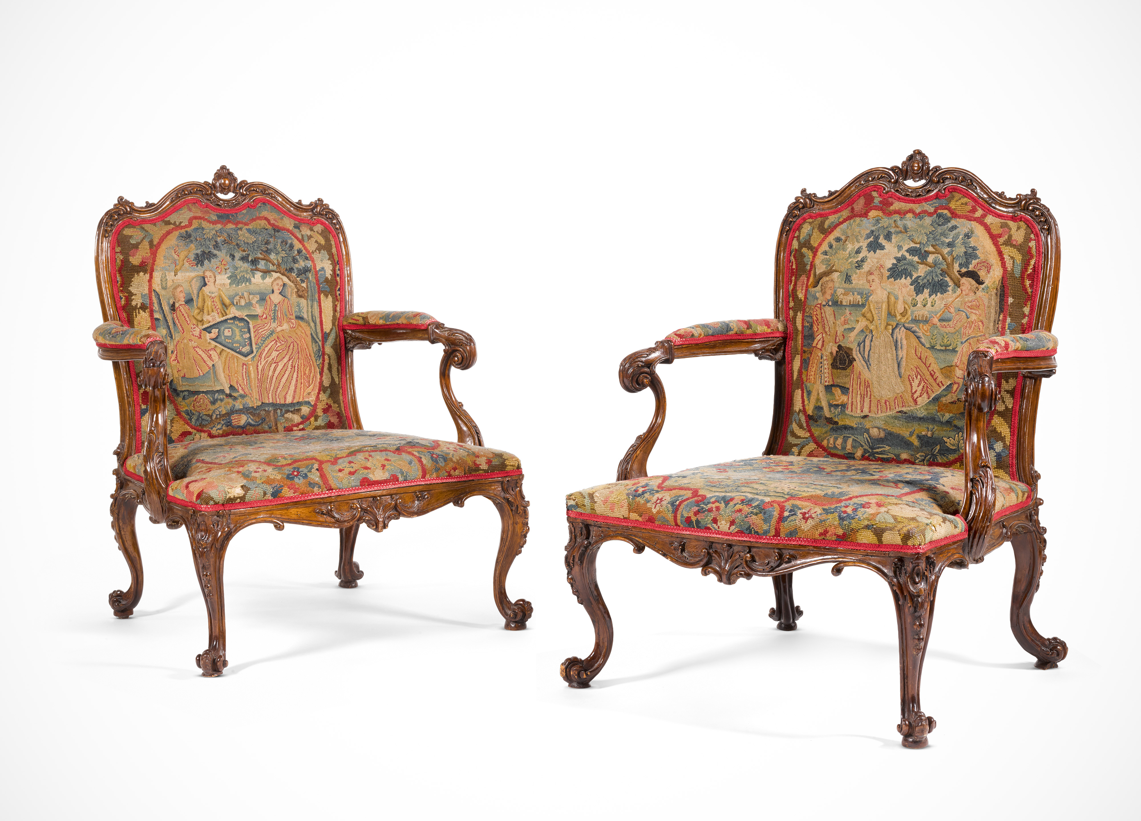 A pair of George III carved fruitwood library armchairs, circa 1760, in the manner of Thomas Chippendale