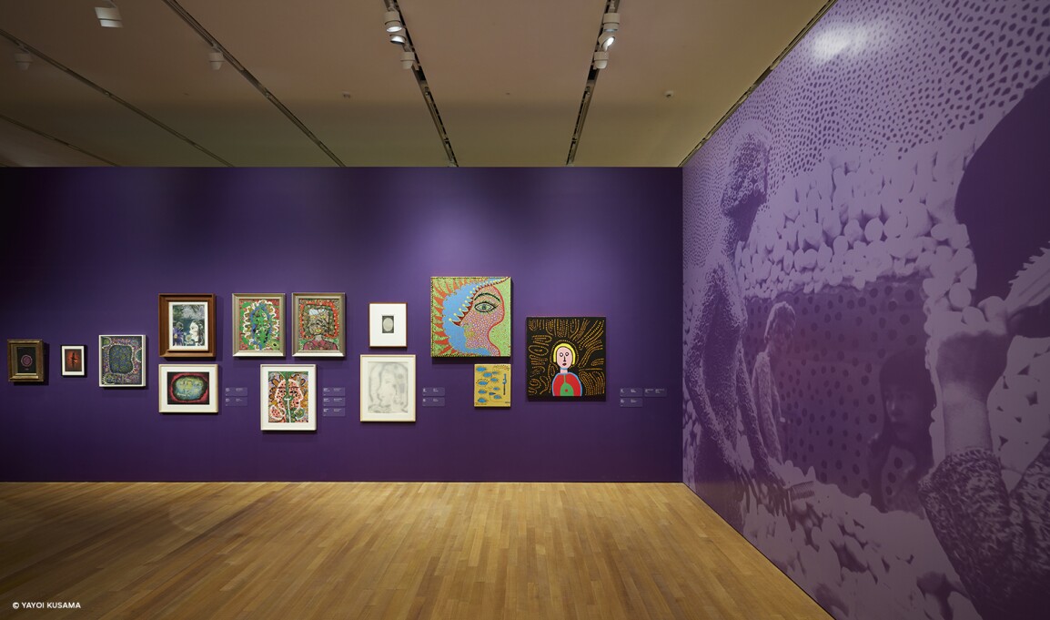 View of the Yayoi Kusama robot painting spots on the window of the