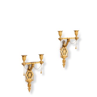 View 1 of Lot 575: A pair of Louis XVI style gilt-bronze two-light wall appliques, 19th century, in the manner of Francois Rémond