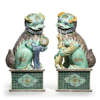 View 1 of Lot 85: A large and impressive pair of famille-verte biscuit Buddhist lions Qing dynasty, Kangxi period | 清康熙 五彩佛獅一對