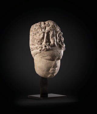 View 1 of Lot 243: A monumental buff sandstone head of a Devi North India, 9th-10th century | 印度北部 九至十世紀 砂岩雕提毗首
