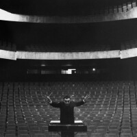 Yves Klein conducting in an empty auditorium, 1958. 