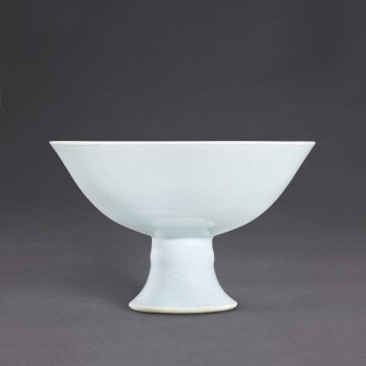 View 1 of Lot 3520: A white anhua-decorated 'bajixiang' stem bowl, Mark and period of Yongzheng | 清雍正 白釉暗花八吉祥高足盌 《大清雍正年製》款