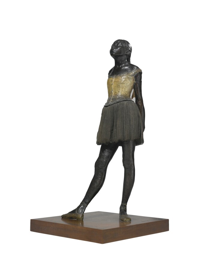 Sculpture of a dancer with her hands clasped behind her back.