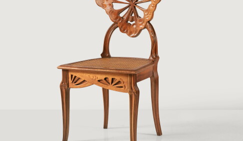 Émile Gallé, La Berce des Prés or Ombelles chair, circa 1902. Carved walnut and cane, Signed Gallé on one leg. Estimate €8,000-12,000.
