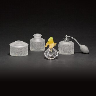 View 1 of Lot 47: A Daum glass scent bottle and stopper and a three-piece Lalique ‘Enfant’ dressing table set, modern