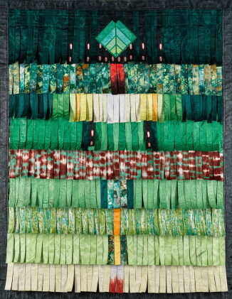 Textile artwork featuring layered green and red fabric strips arranged in a geometric pattern.