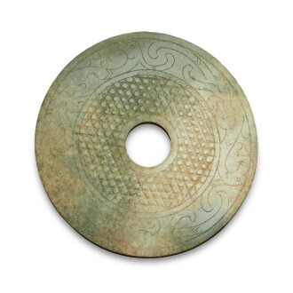 View 1 of Lot 222: A celadon jade 'mythical bird' disc (Bi), Warring States period / Han dynasty | 戰國 / 漢 玉瑞鳥蒲紋璧