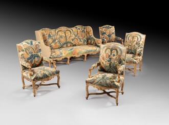 View 1 of Lot 25: A set of giltwood and petit point needlework seat furniture, early Louis XV | Mobilier de salon en hêtre redoré et broderie au petit point, début de l'époque Louis XV