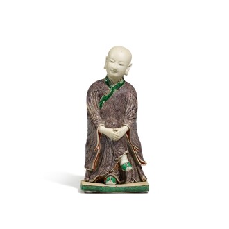 View 1 of Lot 79: A biscuit enamelled figure of a seated monk Qing dynasty, Kangxi period  | 清康熙 素三彩和尚坐像