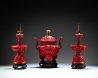 View 1 of Lot 113: A pair of carved cinnabar lacquer candlesticks and a carved cinnabar lacquer incense burner, Marks and period of Qianlong | 清乾隆至嘉慶 剔紅八寶番蓮紋燭台一對 及 剔紅八寶番蓮爐連蓋《大清乾隆年製》