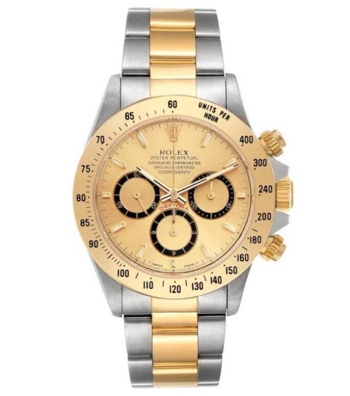 Close-up of the Rolex Cosmograph Daytona Reference 16523 featuring a yellow gold case and rare champagne dial with the early-production 'Inverted 6' subdial configuration.