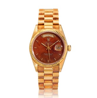 View 1 of Lot 38: Reference 18038 Day-Date, A yellow gold automatic wristwatch with day, date, bracelet and wood dial, Circa 1985  勞力士 18038型號 Day-Date 黃金自動上鏈鍊帶腕錶備星期及日期顯示，配木製錶盤，約1985年製