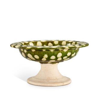 View 1 of Lot 3013: A green and cream-glazed stem bowl, Tang dynasty | 唐 綠釉白斑高足盌