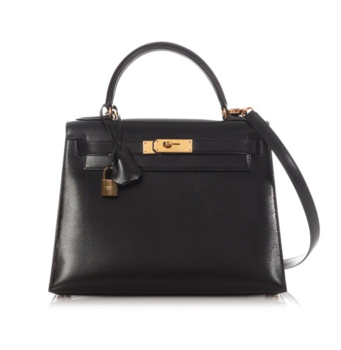 Hermès Vintage Sellier Kelly 28 in Black Box Calf leather with gold hardware, shown with lock, keys, clochette, and dust bag against a neutral background.