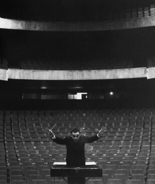 Yves Klein conducting in an empty auditorium, 1958. 