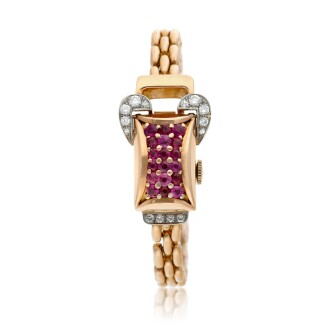 View 1 of Lot 163: A pink gold diamond and ruby-set concealed bracelet watch, Circa 1940