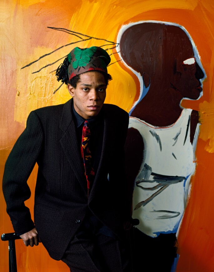 21 Facts About Jean-Michel Basquiat: Portrait in front of a yellow painting