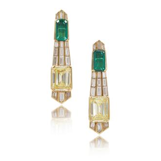 View 1 of Lot 571: Impressive pair of Fancy Intense Yellow diamond, emerald and diamond pendent earrings, circa 1979