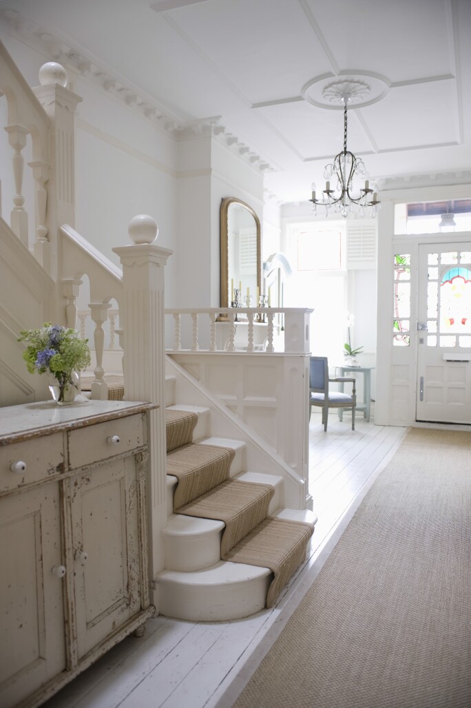 Photo of stairway with neutral colored rug.