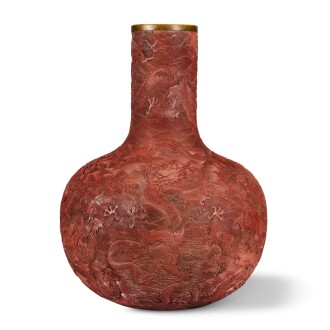 View 1 of Lot 35: An impressive and rare large carved cinnabar lacquer 'nine dragon' vase, Tianqiuping Qing dynasty, Qianlong period | 清乾隆 剔紅海水九龍紋天球瓶