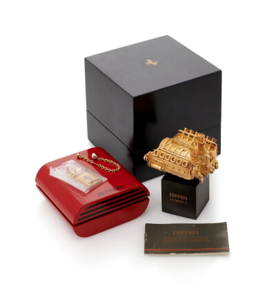 Catalog image of an emerald, ruby and diamond pendant/keychain and ferrari engine scale model (p…