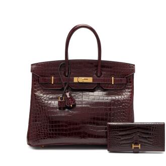 View 1 of Lot 46: Set of Two Bordeaux Shiny Porosus Crocodile Birkin 35 Gold Hardware, 2014 and a Bordeaux Shiny Alligator Mississippiensis Bearn Wallet Gold Hardware, 2013