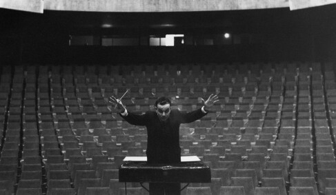 Yves Klein conducting in an empty auditorium, 1958. 