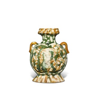 View 1 of Lot 171: A molded sancai-glazed pottery pilgrim's flask, Tang dynasty | 唐 三彩印樂舞圖扁壺