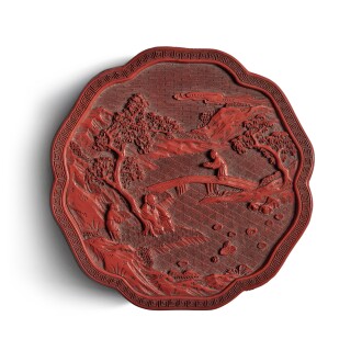 View 1 of Lot 578: A carved cinnabar lacquer lobed 'figural' box and cover, Qing dynasty, Qianlong period | 清乾隆 剔紅松下高士圖葵式蓋盒