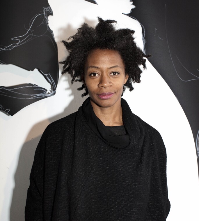 Photograph of woman in front of silhouette artwork