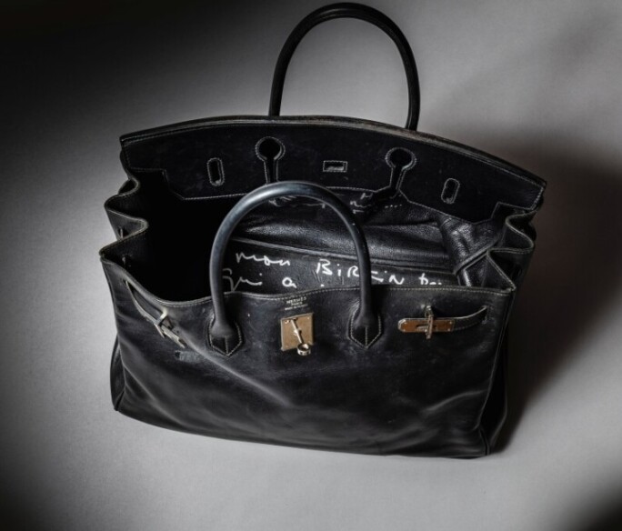 A black Hermès Birkin 40 handbag in Box leather, previously owned by Jane Birkin, featuring distinctive closed bridges and visible wear from use, photographed ahead of its auction at Sotheby’s Abu Dhabi.