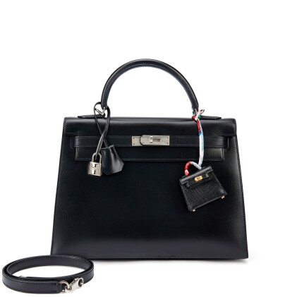 View 1 of Lot 943: Set of Two Limited Edition Black Box Kelly 32 Sellier Guilloche Palladium Hardware, 2013 and Black Shiny Niloticus Lizard Micro Mini Twilly Kelly Bag Charm Gold Hardware, 2019