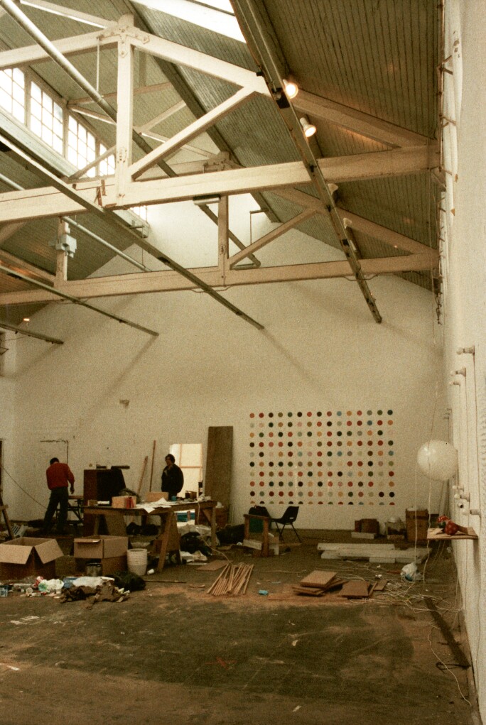 Port London Authority building Room 2, Freeze exhibitions, showing a Damien Hirst spot painting on the wall, various Angela Bulloch light sculptures, Mat Collishaw in doorway, 1988-89. © Abigail Lane. All Rights Reserved, DACS/Artimage 2018.