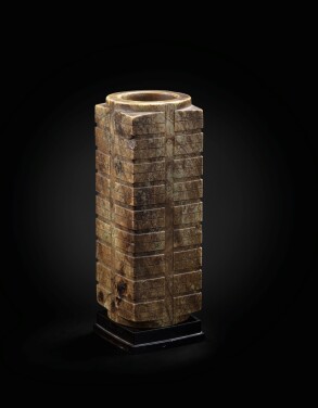 View 1 of Lot 29: A large mottled brown jade nine-tier archaistic cong Ming dynasty or earlier | 明或更早期 青玉琮