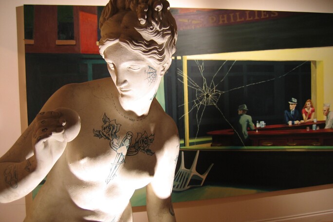 An installation view of Banksy's Crude Oils exhibition in London in 2004 with adapted versions of the Venus de Milo and Edward Hopper's Nighthawks.