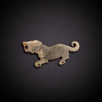 View 1 of Lot 3473: A celadon jade 'tiger' pendant, Western Zhou dynasty or later | 西周或更晚 青玉虎紋珮