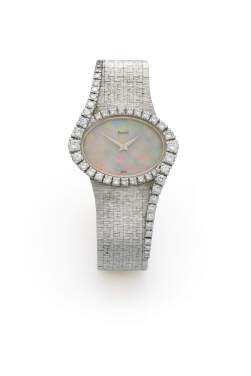 View 1 of Lot 8: Ref. 9857 A6  White gold and diamond-set bracelet watch with opal dial  Circa 1975