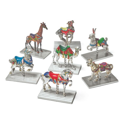 Catalog image of a group of seven silver and enamel carousel figures, designed by gene moore for…