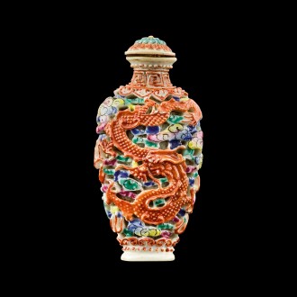 View 1 of Lot 1003: A famille-rose porcelain 'dragon and phoenix' snuff bottle Seal mark and period of Jiaqing | 清嘉慶 粉彩雕瓷龍鳳呈祥紋鼻煙壺 《嘉慶年製》款