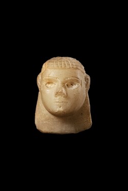 View 1 of Lot 106: A South Arabian Alabaster Relief Head, 3rd Century B.C./1st Century A.D.