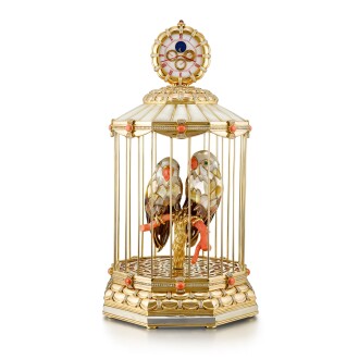 View 1 of Lot 2161: Reference G3221 A | A yellow gold and gold plated brass, diamond, emerald, pink coral and mother-of-pearl-set perpetual calendar desk clock with singing bird mechanism, day, date and moon phases, Circa 1980 | Gérald Genta | 型號G3221 A |  黃金及鍍金銅製鑲鑽石、綠寶石、粉紅珊瑚及珠母貝萬年曆座鐘，備鳥鳴機關，日期、星期及月相顯示，約1980年製