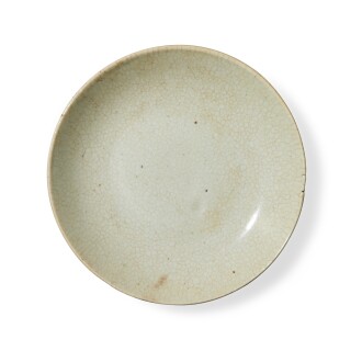 View 1 of Lot 732: A crackle-glazed dish, Ming dynasty | 明 白釉盤