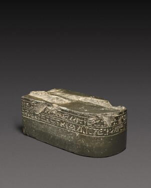 View 1 of Lot 144: An Egyptian Greywacke Inscribed Statue Base, Late Period, 712-30 B.C
