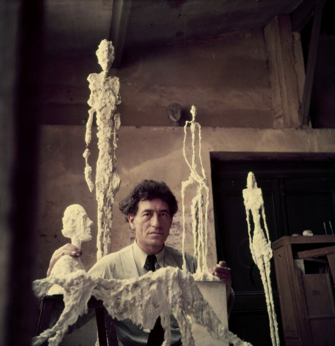 Swiss artist Alberto Giacometti surrounded by sculptures in his studio, 1952.