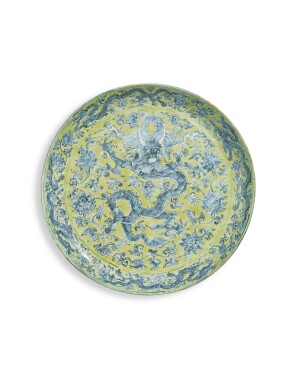 View 1 of Lot 1071: A massive yellow-ground underglaze-blue 'dragon' charger, Mark and period Jiajing | 明嘉靖　黄地青花穿蓮龍紋大盤　《大明嘉靖年製》款
