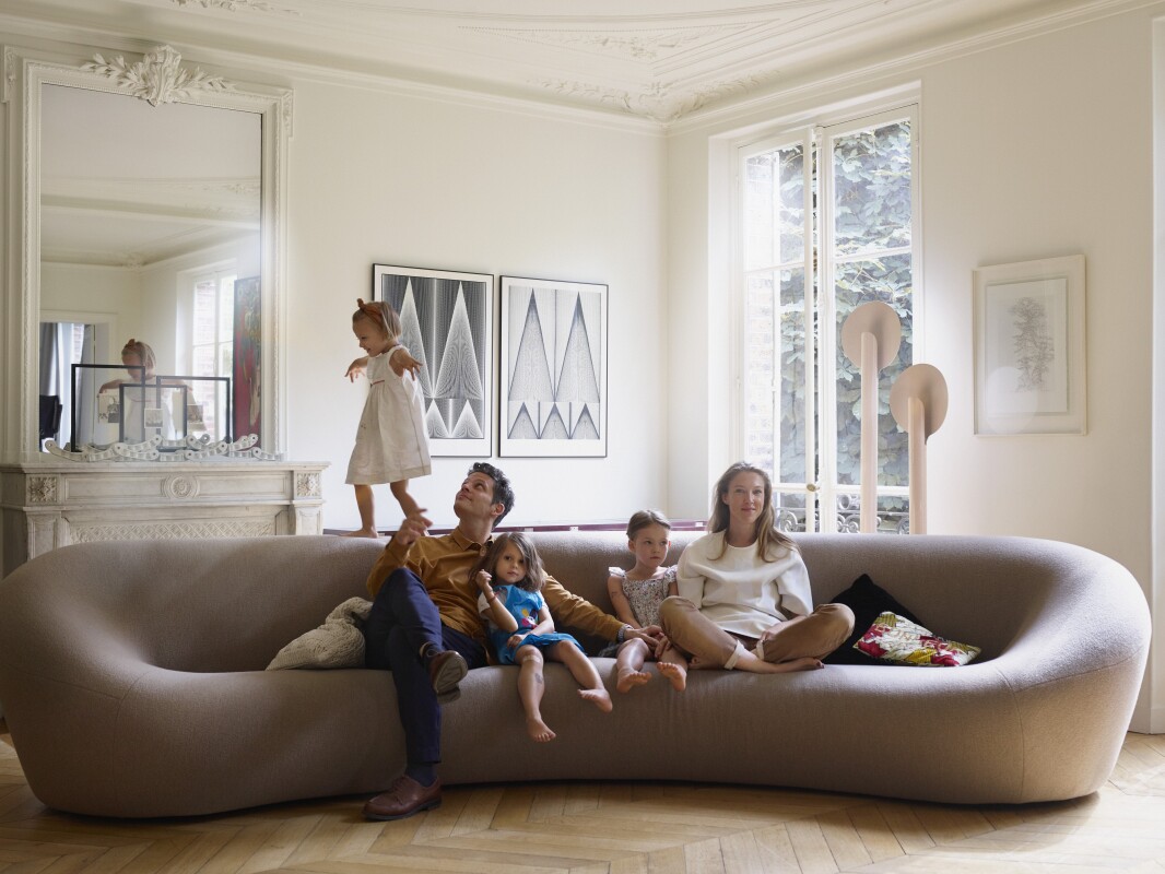 Benjamin Paulin and Alice Lemoine at home in Paris on the Pierre Paulin Big C Sofa