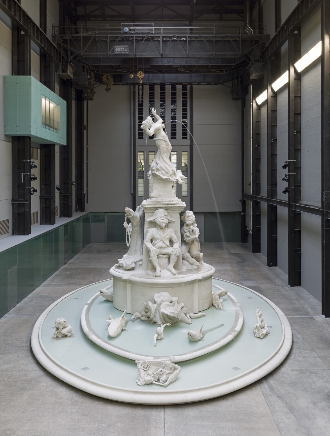 A large-scale white statue in an industrial hall