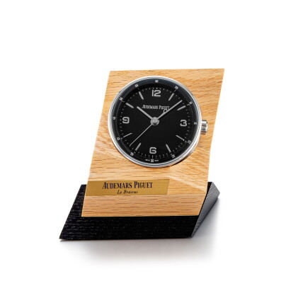 Catalog image of Code 11.59 | A stainless steel alarm desk clock with wooden stand, Circa 2019 |…