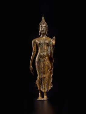 View 1 of Lot 846: A gilt-bronze figure of a walking Shakyamuni Buddha, Thailand, Sukothai, circa 14th century